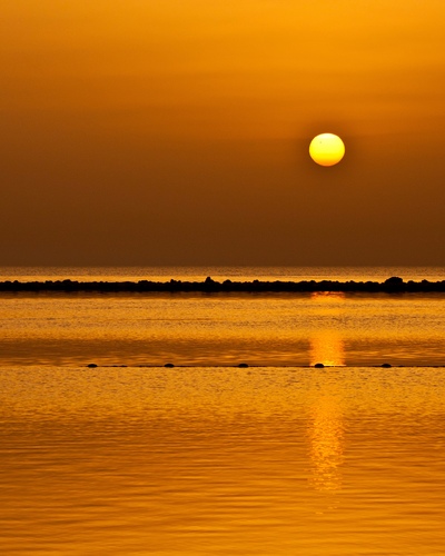 The transit of Venus taken at dawn on June 6, 2012 from Amwaj Island, Bahrain. Venus is visible as a small black dot passing across the face of the Sun. This is a rare occurence and won't happen again until 2117.