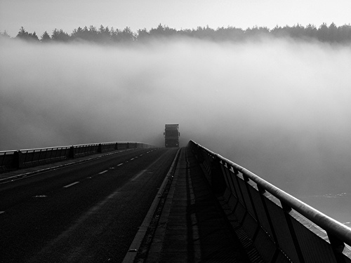 I was standing on Youghal Bridge trying to get something of the mist as it crept over. I noticed the truck entering the mist further round the bend and decided to wait and get it as it came out. 