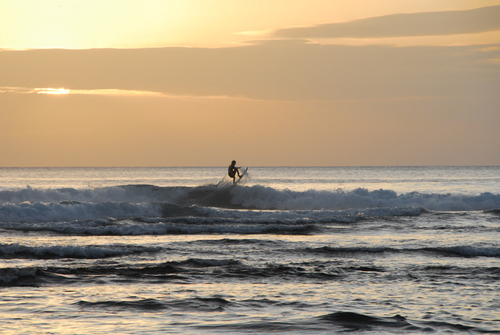 A surfer getting air at Ulu Watu, Bali.